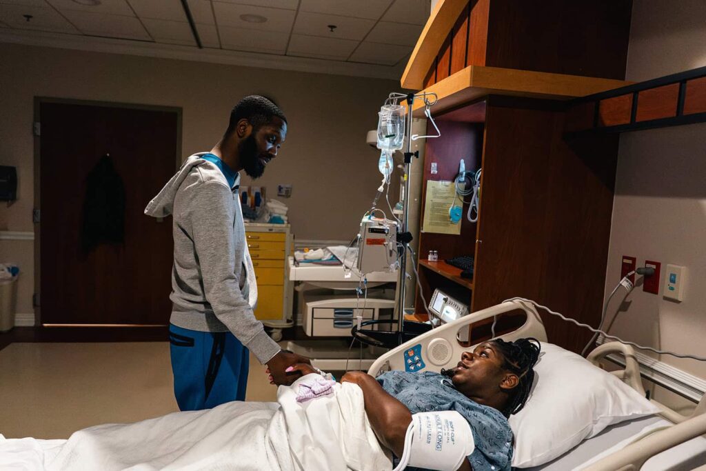 Middle Tennessee birth photography showing a husband comforting his wife before the baby’s delivery