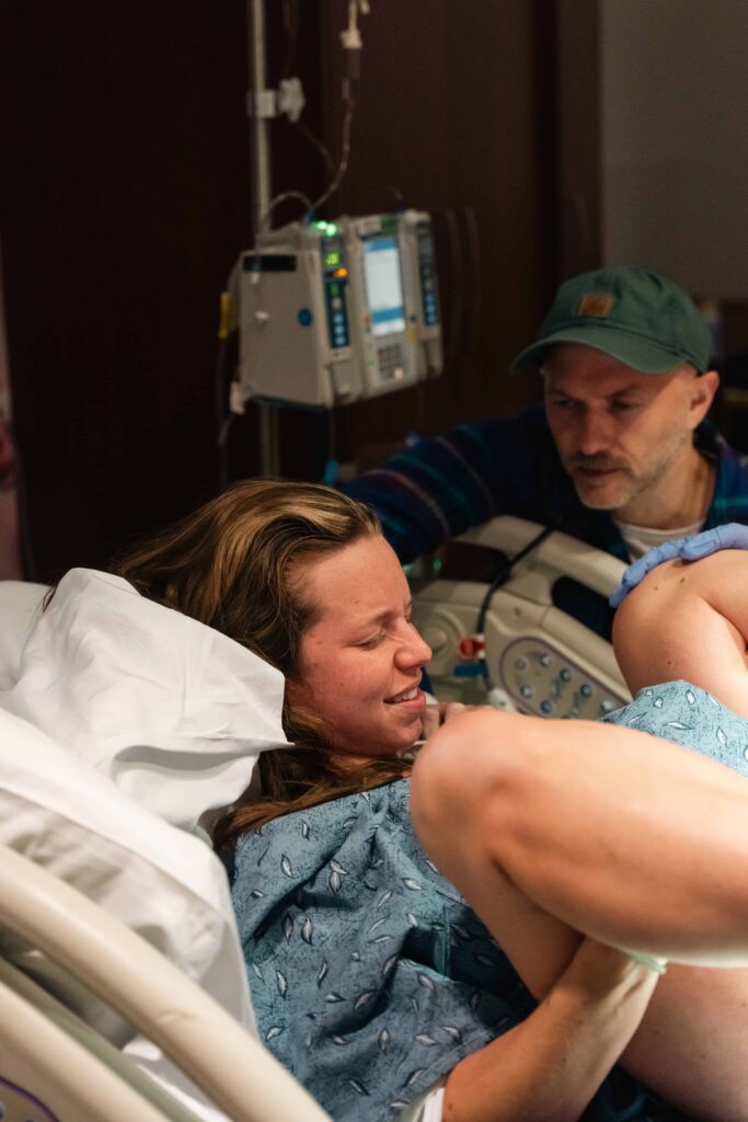 Middle Tennessee birth photography showing a mother experiencing labor pains during delivery