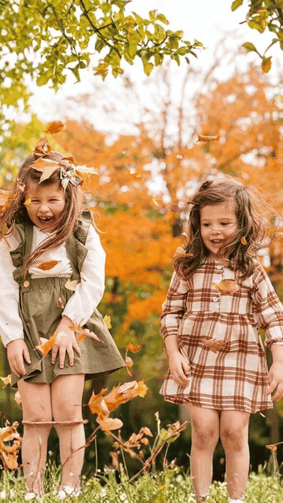 Children playing and enjoying an outdoor photography session during the fall season