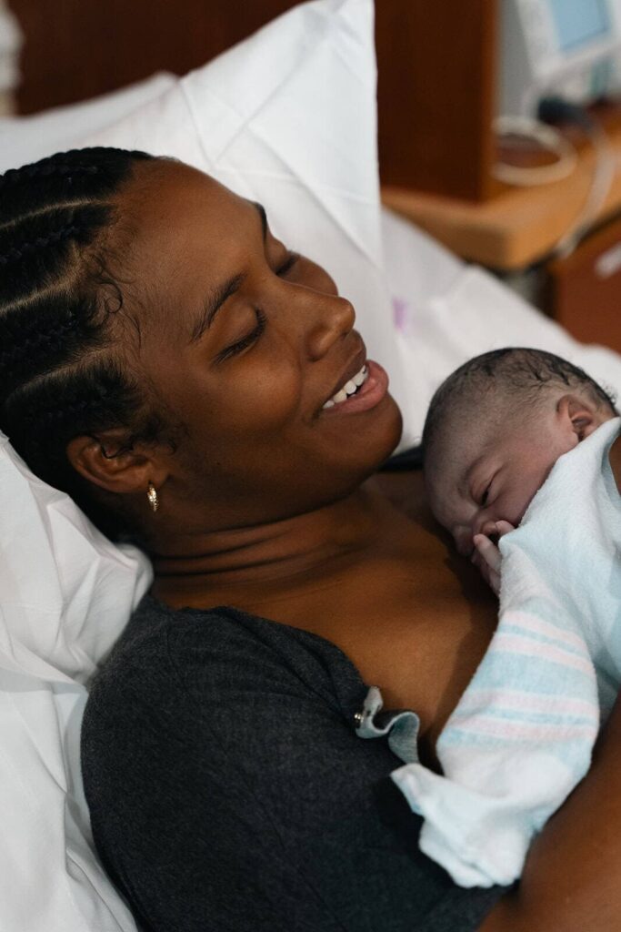 Birth photography session by D. Layne Photography showing a mother holding her newborn at the hospital