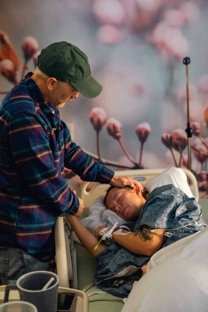 Labor and delivery photography session in Murfreesboro, showing the husband comforting her wife during labor