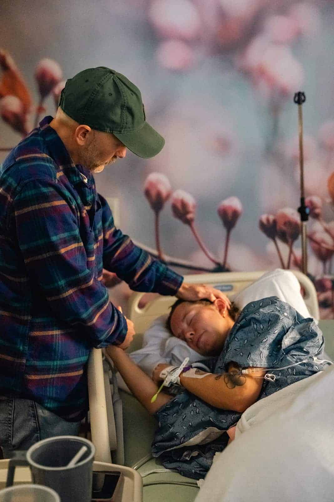 Labor and delivery photography session in Murfreesboro, showing the husband comforting her wife during labor