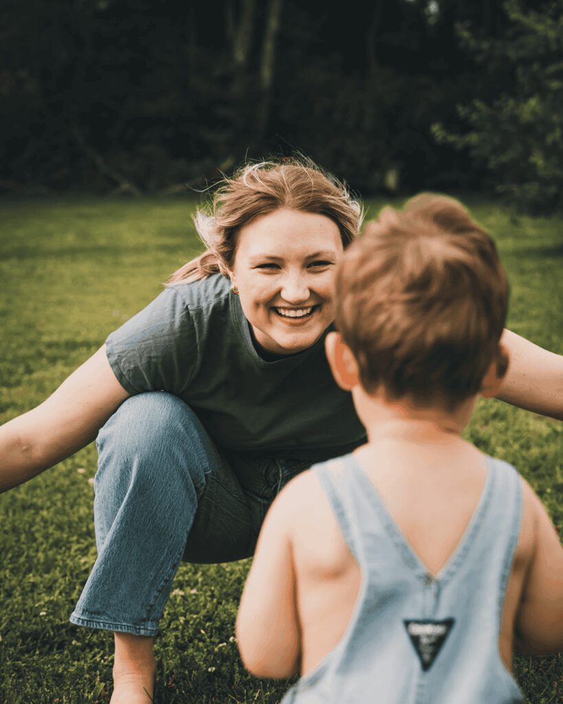 Mom and son share a tender moment during an outdoor family portrait photography session